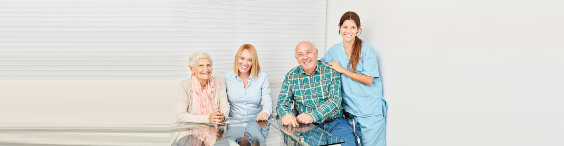 two caregiver and two seniors smiling